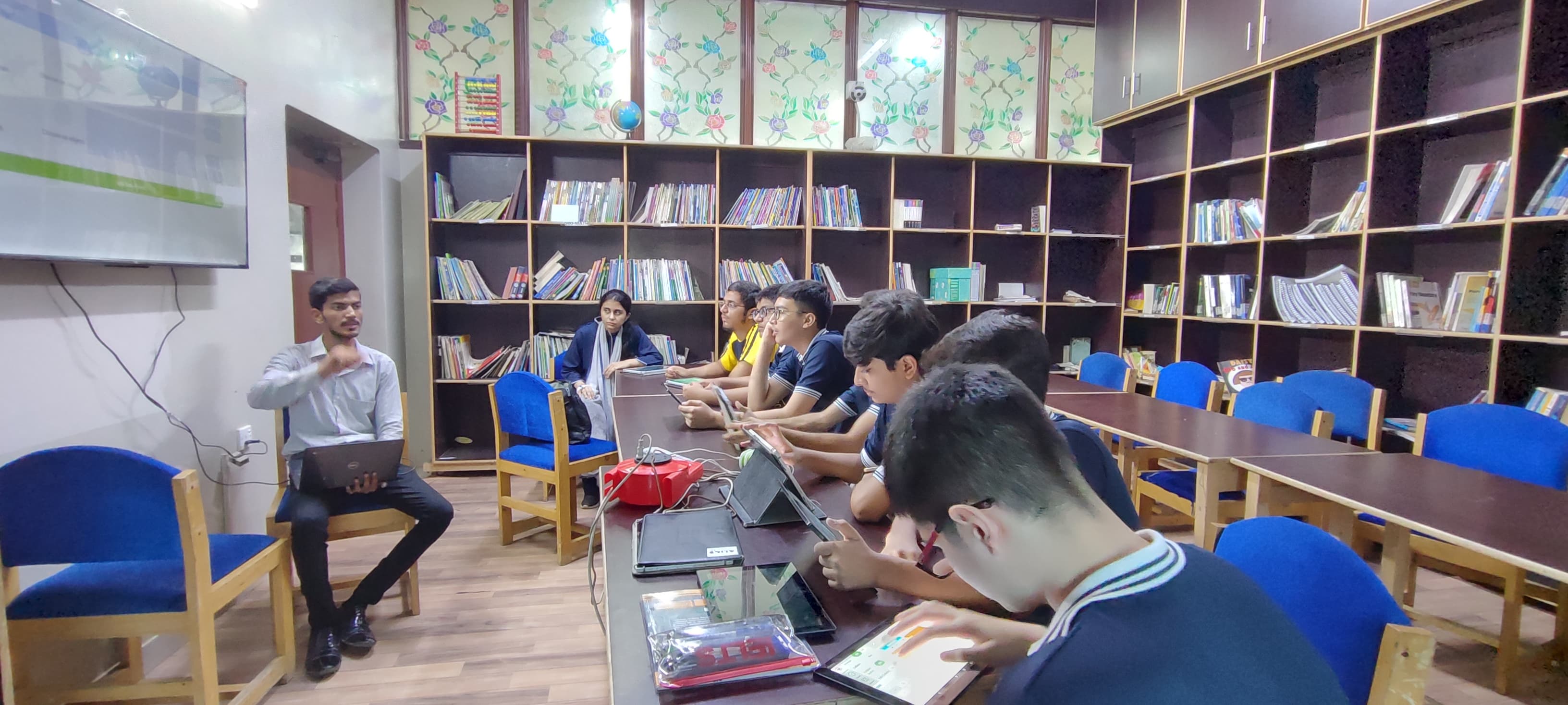 Teacher guiding Horizon High students in a library learning session